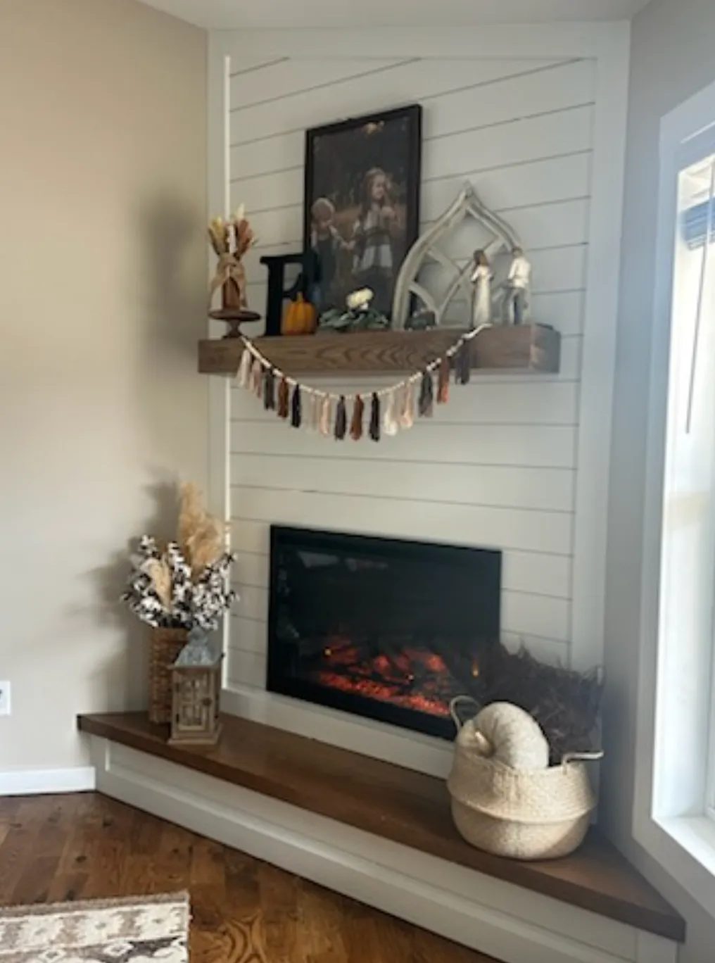Contemporary shiplap fireplace with wood mantel and decorative styling