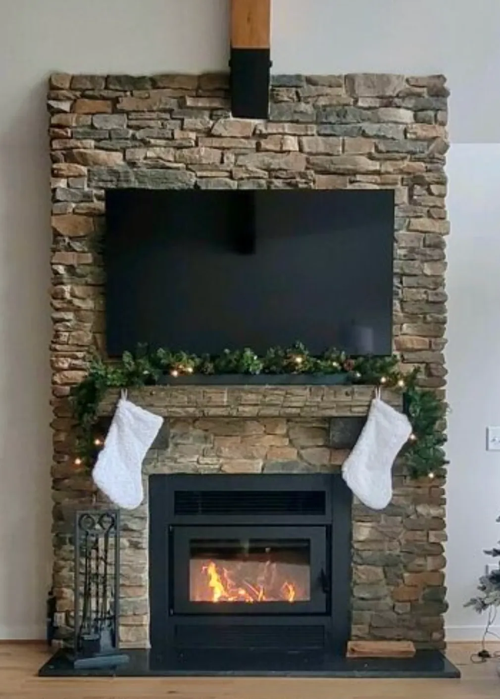 Stone fireplace with TV mount and Christmas decorations