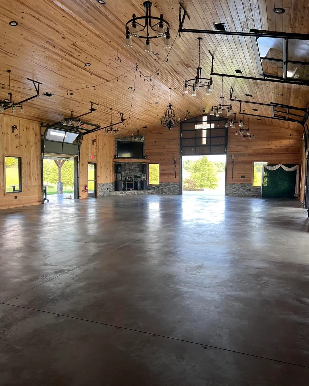 Interior view of the barn with polished concrete floors and chandeliers