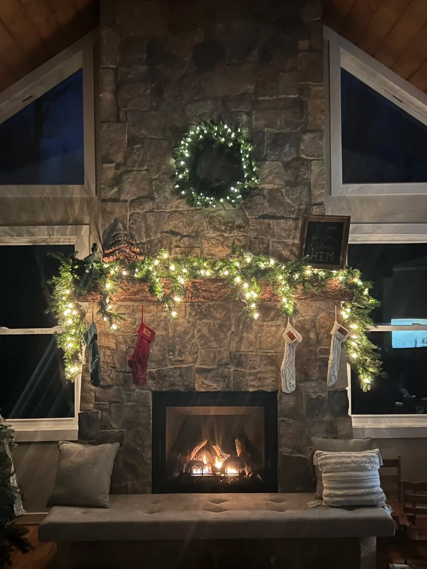 Grand stone fireplace with Christmas garland and seasonal decorations