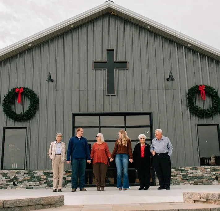 Family photo in front of The Barn at Wall's Pond