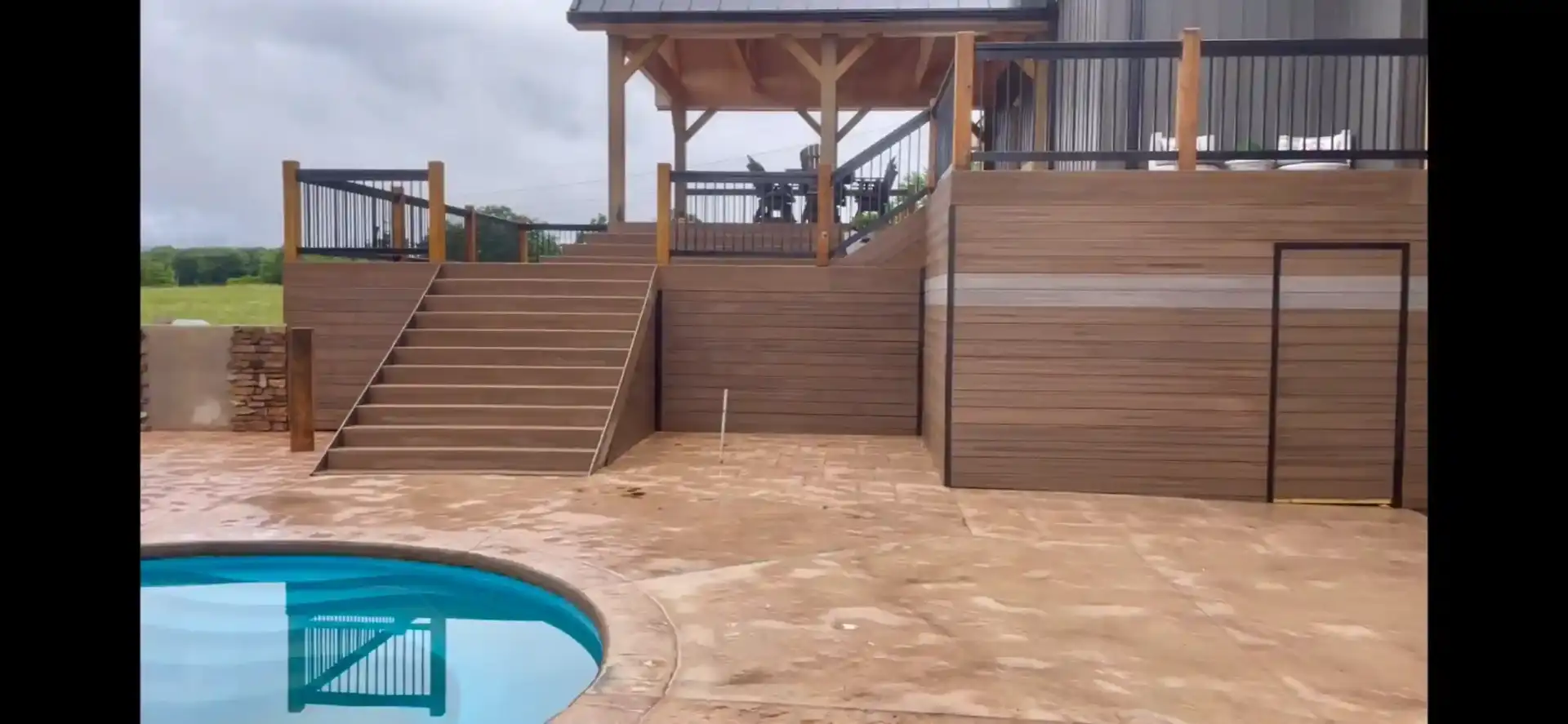Multi-level deck design with pool area and modern railings