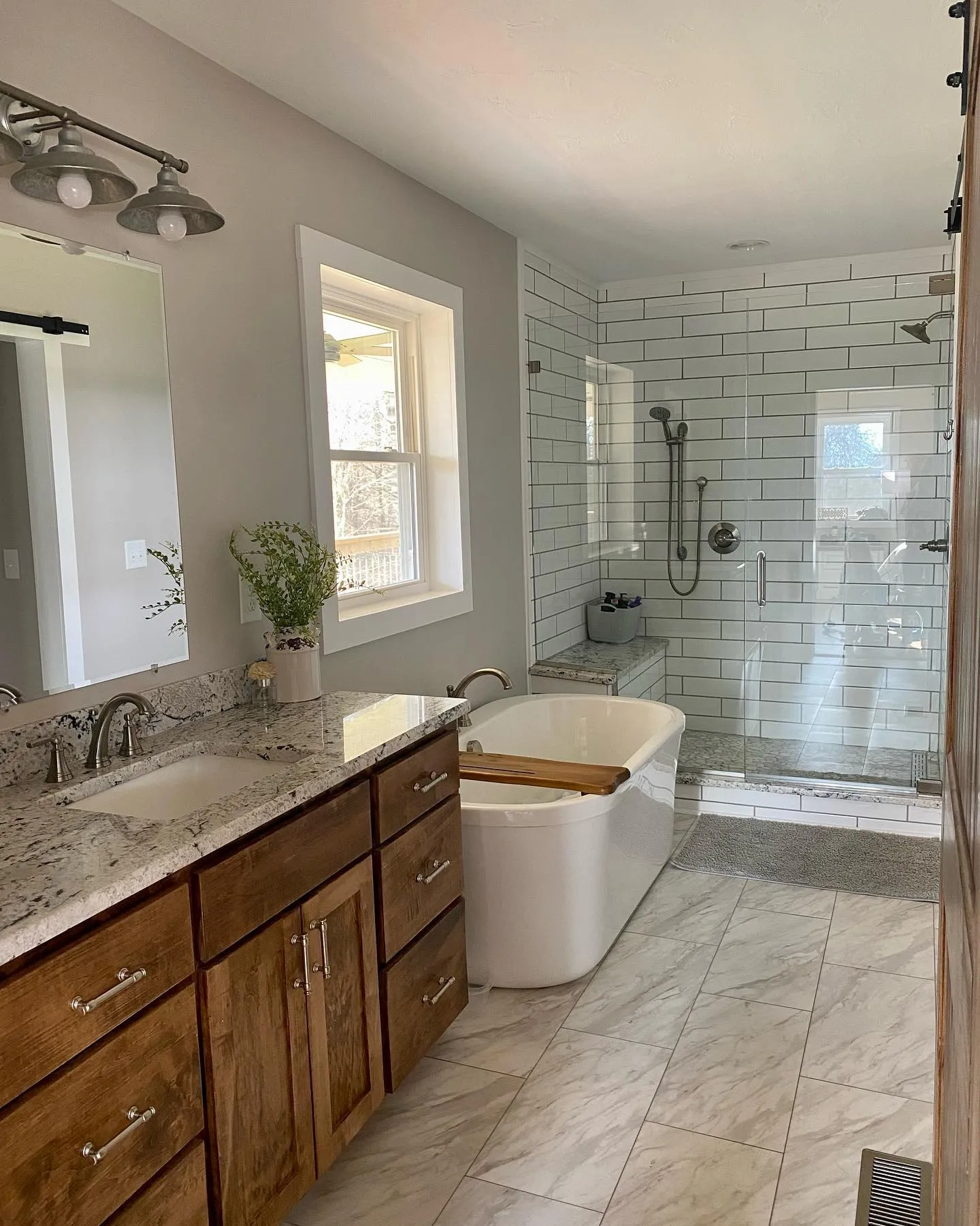Spacious bathroom with subway tile shower and freestanding tub