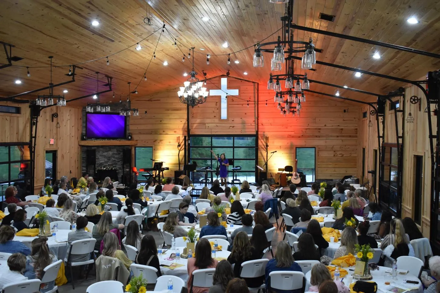 Interior event with guests seated at decorated tables