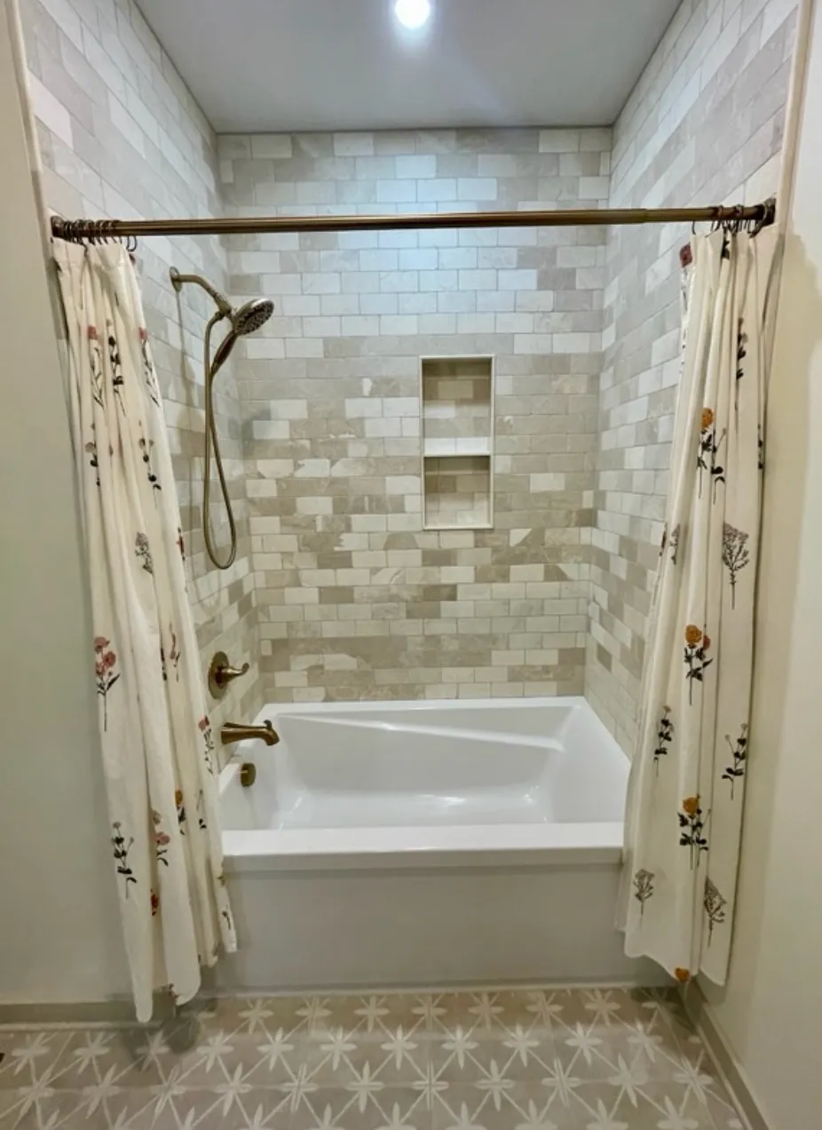 Bathroom with marble subway tile and tub/shower combination
