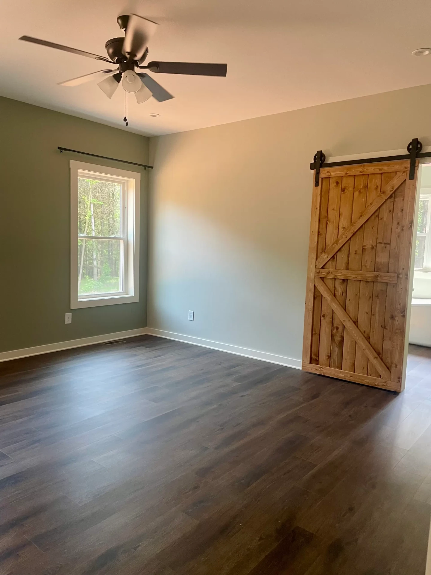 Rustic barn door on sliding track in modern room