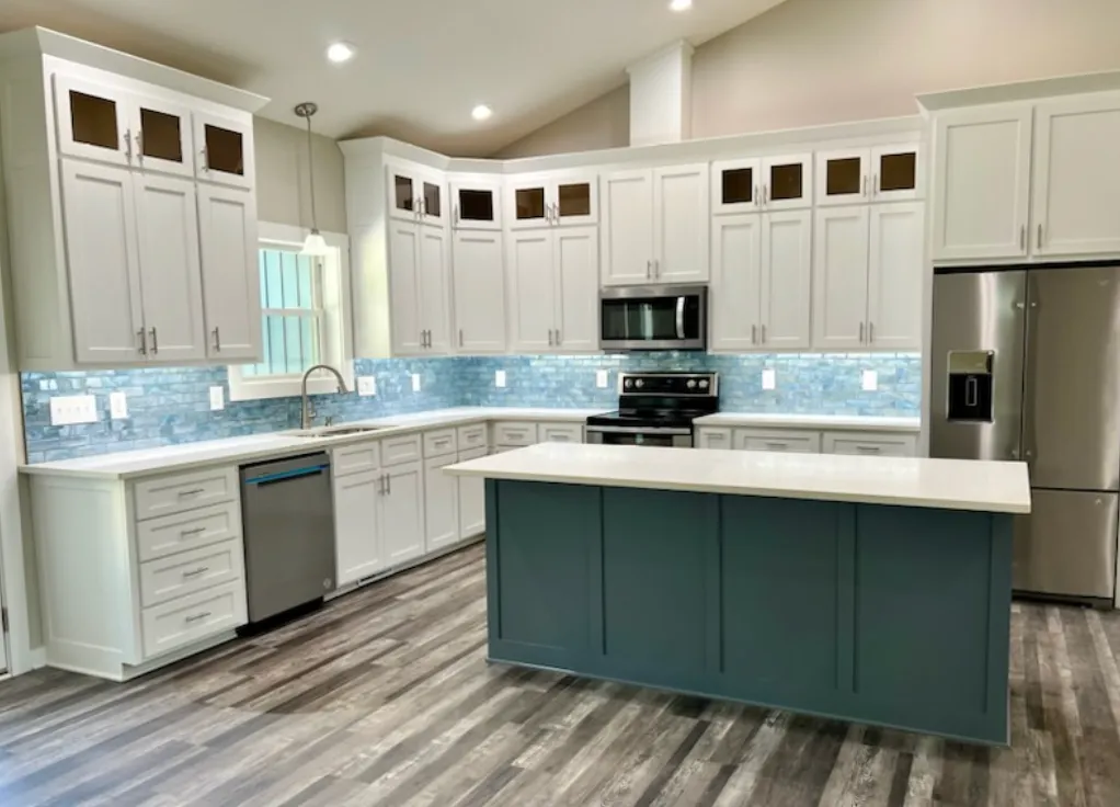 Modern kitchen with white cabinets and blue backsplash
