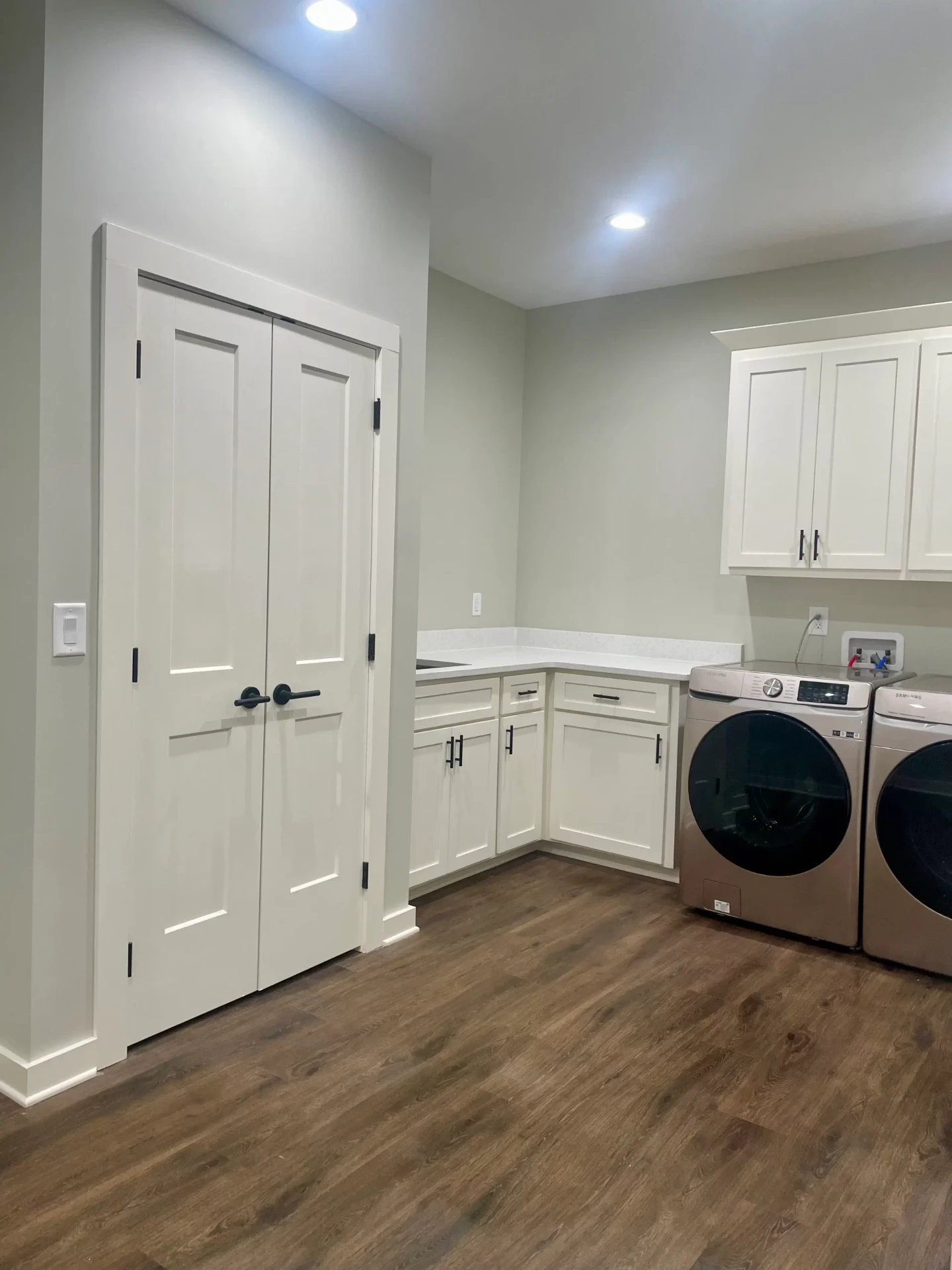 Modern laundry room with white cabinet doors and storage solutions