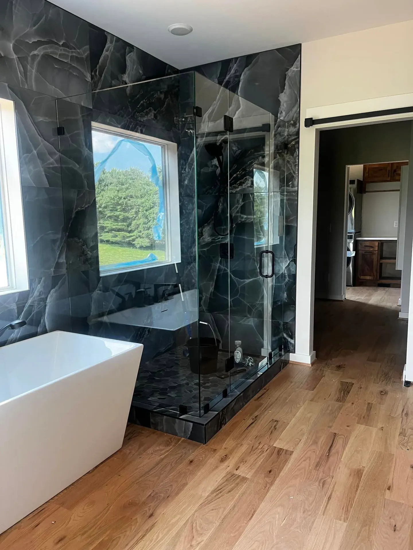 Luxury bathroom with dramatic black marble shower and freestanding tub