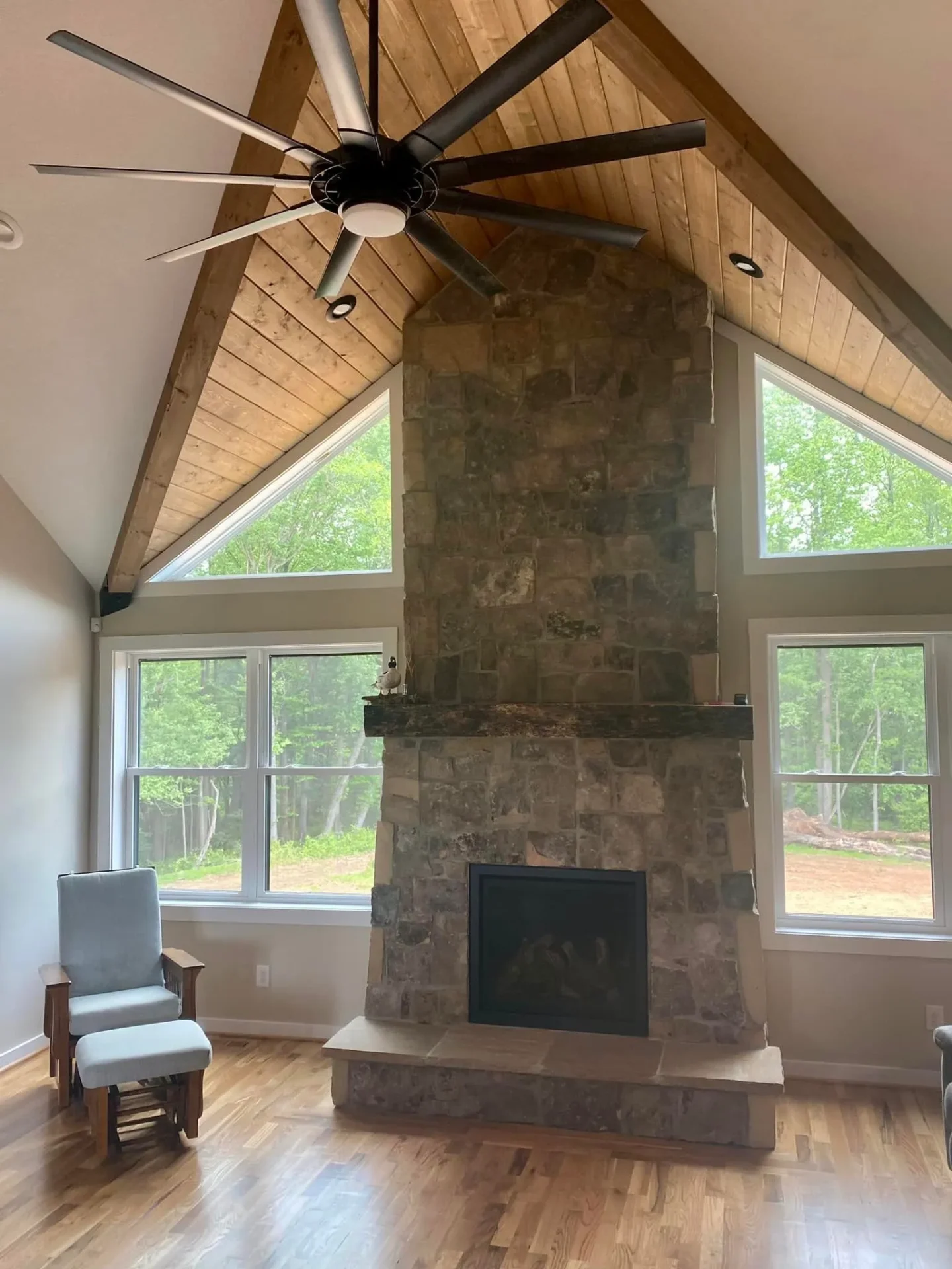 Rustic stone fireplace with vaulted ceiling and exposed beams