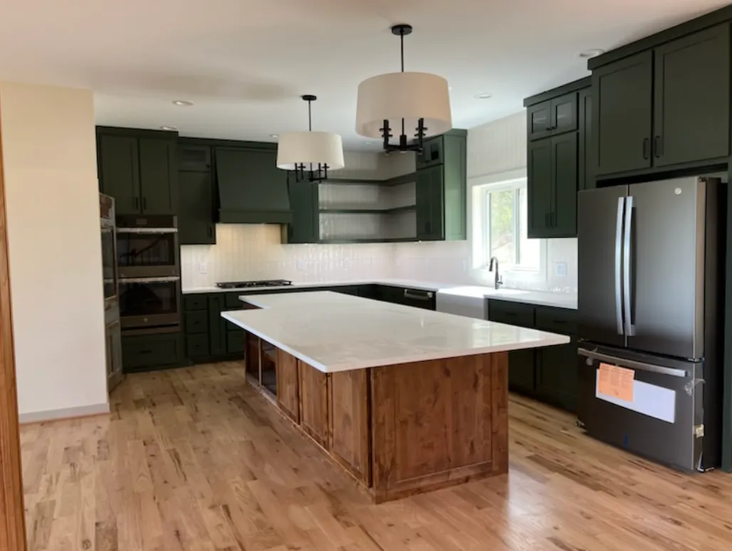 Dark green kitchen with wood island
