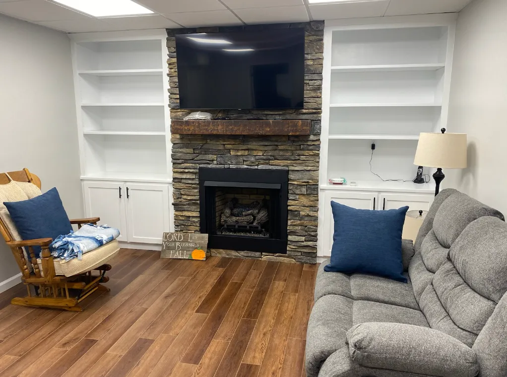Family room with stone fireplace and built-in shelving